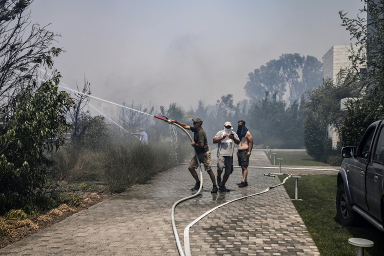 Κάτοικοι δίνουν μάχη με τη φωτιά στο Κιοτάρι και το Γεννάδι, στο ελληνικό νησί της Ρόδου, στις 24 Ιουλίου 2023 (AFP - Σπύρος ΜΠΑΚΑΛΗΣ)